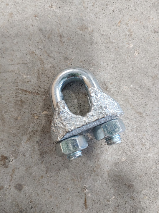 A close up of an old metal clamp