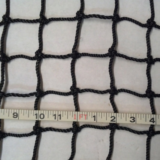 A white cloth with black netting and ruler